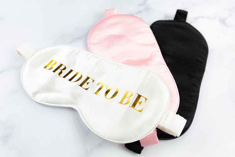two bride to be sleep masks on a marble surface