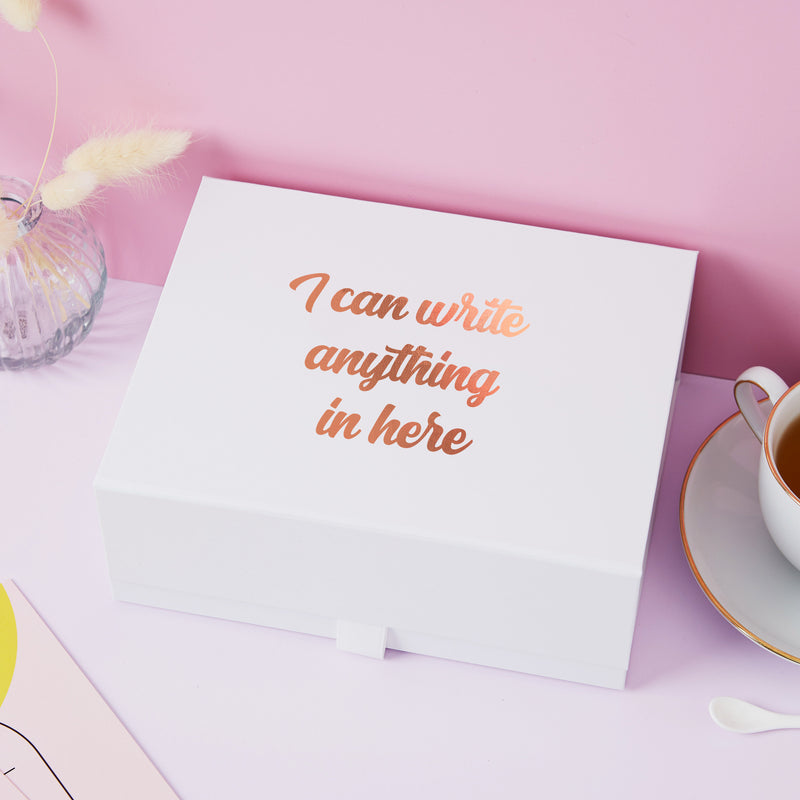 a white box sitting on top of a table next to a cup of coffee