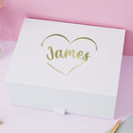 a white box with a gold foiled name on it