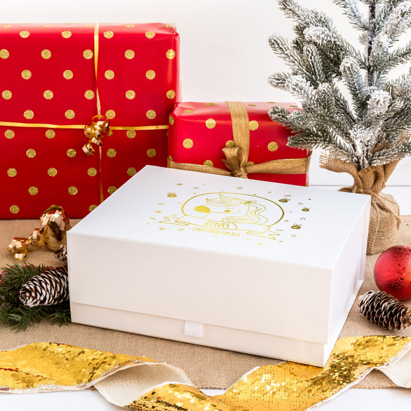 a white box sitting next to a christmas tree