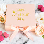 a pink box with a happy 30th birthday written on it