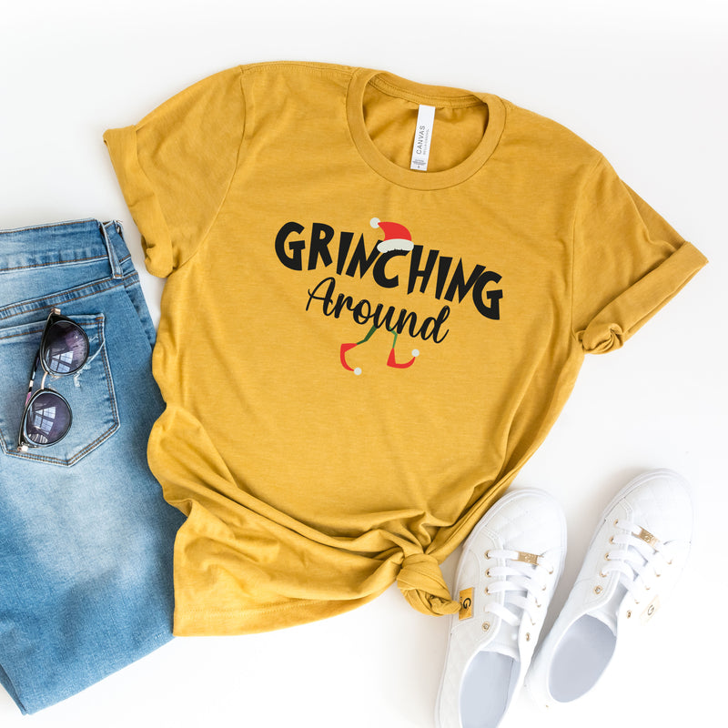 a t - shirt that says grinzing around next to a pair of jeans