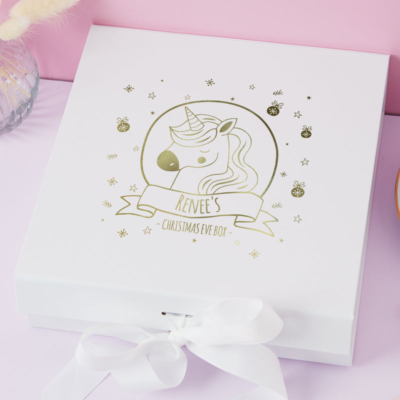 a white box with a gold foil unicorn on it