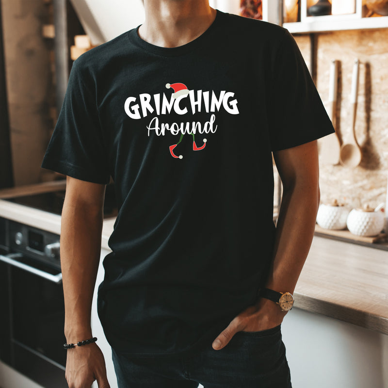 a man standing in a kitchen wearing a black shirt