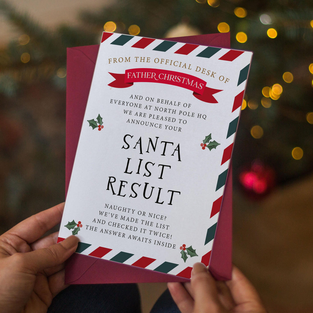 a person holding a Christmas card with a Santa list result. The card has a festive design with red, white, and green colors, and includes text that announces Santa's list result.