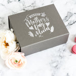 a mother's day gift box with a flower next to it