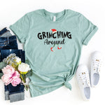 a t - shirt that says grining around next to flowers