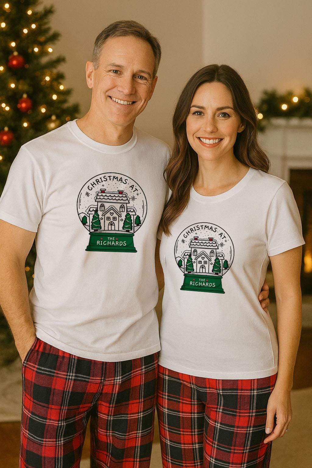 A man and a woman are standing together, both wearing white t-shirts with a Christmas-themed graphic.