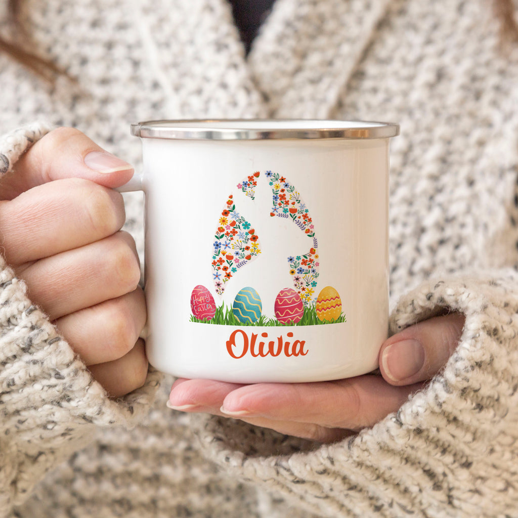 a woman holding a coffee mug with a bunny on it