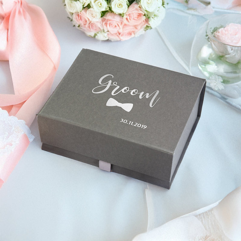 a box with a bow tie sitting on a table