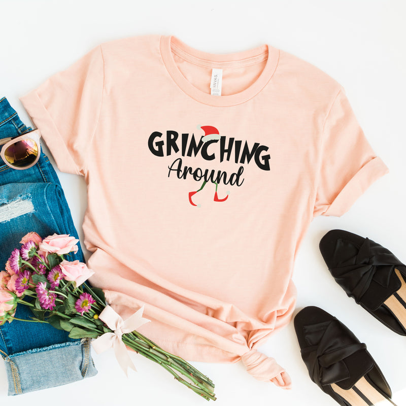 a t - shirt that says grining around next to some flowers