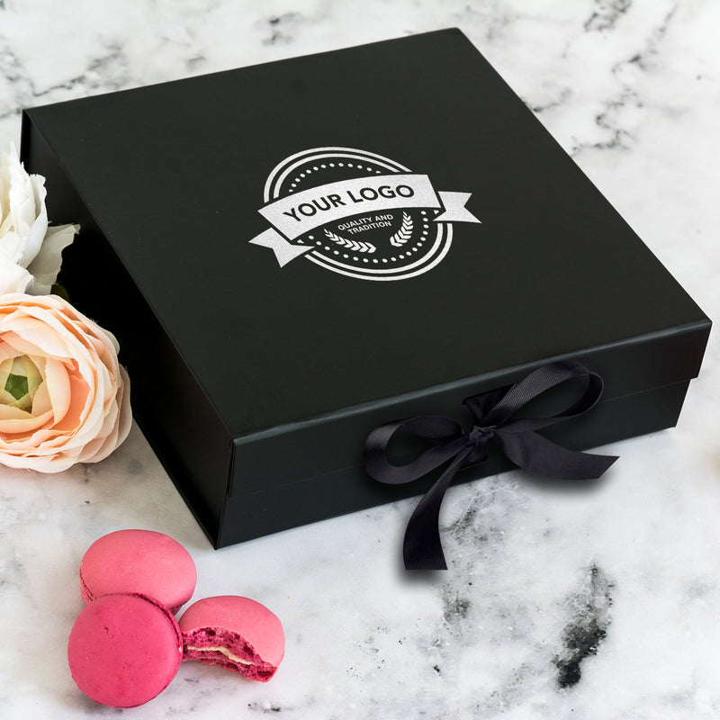 a box of macaroons next to a flower