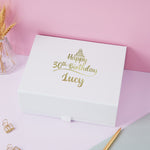 a white box with gold lettering on it