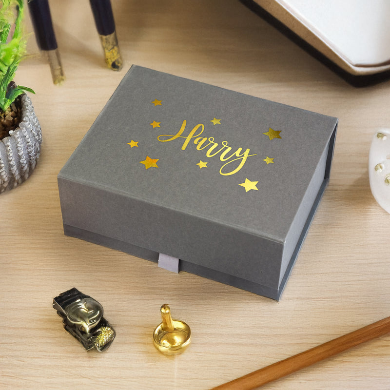 a box that has a gold lettering on it