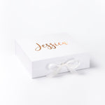 a white box with a white ribbon and a name on it