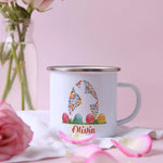 a white coffee mug with a pink rose in the background