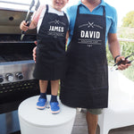 a man and a little boy standing next to a grill