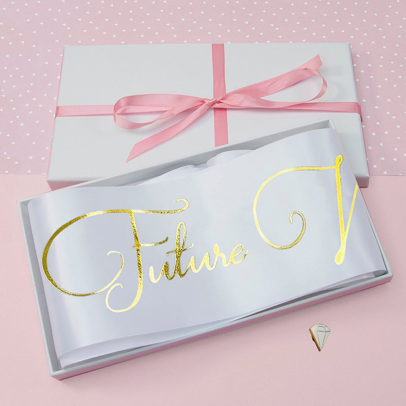 a white box with a pink ribbon and a pink bow