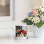 a vase of flowers and a picture frame on a table