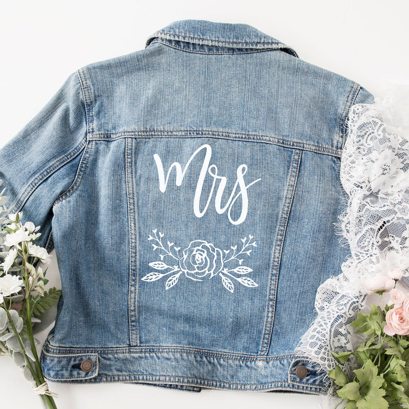 a denim jacket with the word mrs written on it