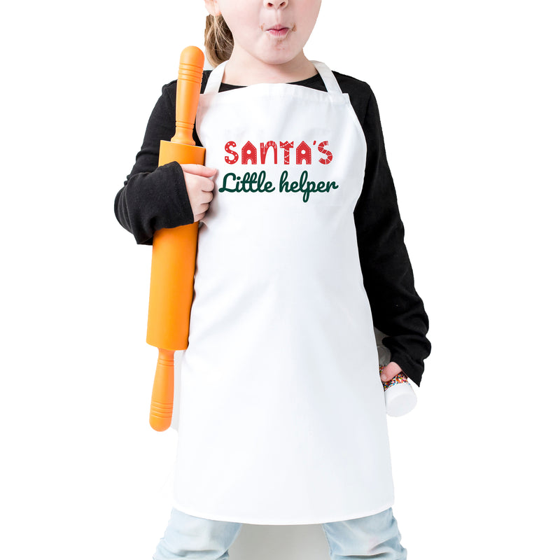 a little girl in a santa's little helper apron holding a baseball bat