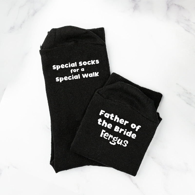 a pair of black socks that say, father of the bride jesus
