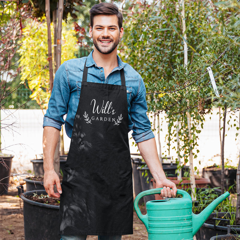 a man in an apron holding a green watering can
